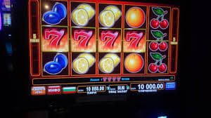 Grand Slam roulette wheel spinning with live dealer operating manual wheel in studio